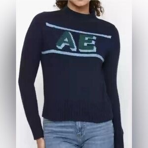 American Eagle logo, mock neck, ribbed hem green and light blue on navy sweater